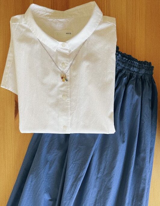 HUIS（ハウス）の白トップスとブルーのスカート